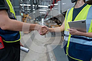 Technical staff and engineers shaking hands.