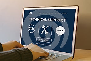 Technical support concept on laptop computer screen on wooden ta