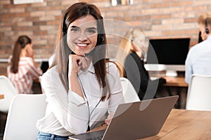 Technical support operator with headset in office