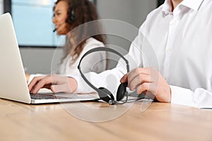 Technical support operator with headset at workplace