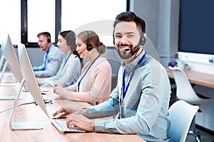 Technical support operator working with colleagues