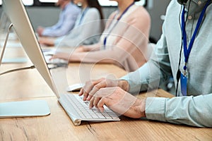 Technical support operator working at table in office, closeup