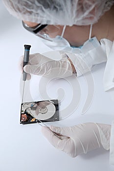 Technical surgeon working on hard drive - data recovery