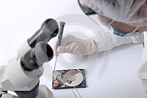 Technical surgeon working on hard drive - data recovery