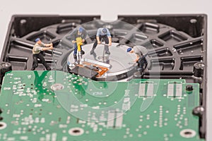 Technicial team miniature people repairing hard drive