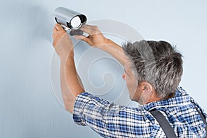 Technician adjusting cctv camera