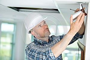 Technician adjusting cctv camera on wall