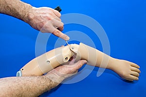 Technician adjusting elbow on artificial arm
