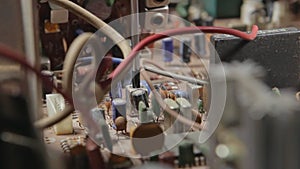 Technician adjusts the board using a screwdriver and a variable capacitor