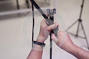 A technician adjusts the microphone stand early in the day before a live concert at a an entertainment bar