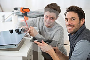 technician and apprentice using silicon gun