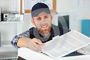 technician assembling air-conditioning unit
