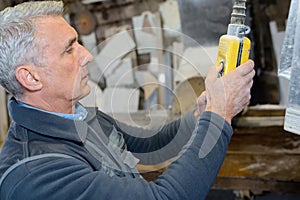 Technician calibrates machine in factory