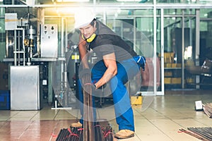 Technician Caucasian male, Working by preparing steel, copper pipes Which are raw materials used industrial applications