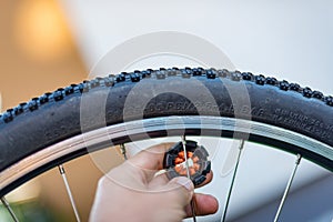 Technician centering bike wheel with dedicated spoke wrench