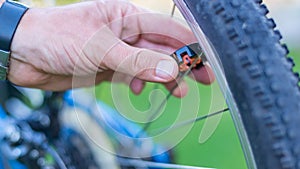 Technician centering bike wheel with dedicated spoke wrench