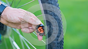 Technician centering bike wheel with dedicated spoke wrench