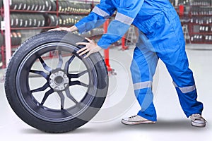 Technician changing a tire at workshop