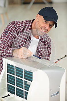 technician checking air conditioner