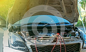 Technician checking air conditioner in engine room of eco car , cleaning air conditioner of car