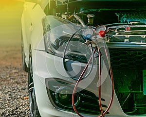 Technician checking air conditioner in engine room of eco car , cleaning air conditioner of car