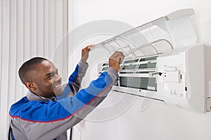 Technician Checking Air Conditioner photo