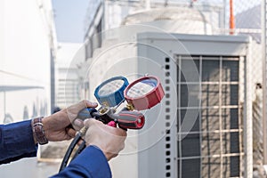 Technician is checking air conditioner ,measuring equipment air conditioners