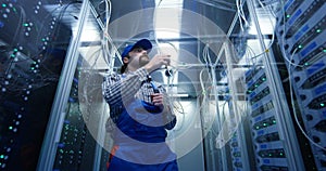 Technician checking cables at a data center