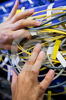 Technician checking cables in a rack mounted server