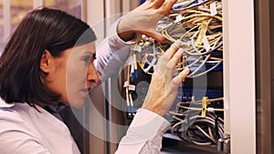 Technician checking cables in a rack mounted server