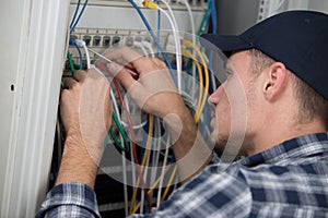 technician checking cables in server