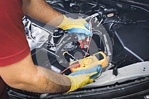 Technician checking DC voltage stable with digital multimeter probe