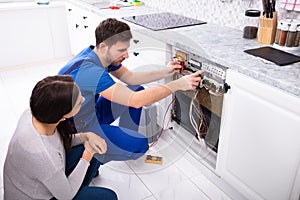 Technician Checking Dishwasher With Digital Multimeter