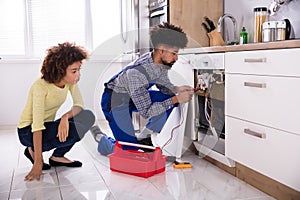 Technician Checking Dishwasher With Digital Multimeter