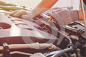 Technician checking or fixing engine of modern car