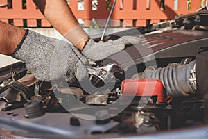 Technician checking or fixing engine of modern car