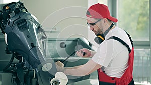 Technician is checking and fixing a motorboat