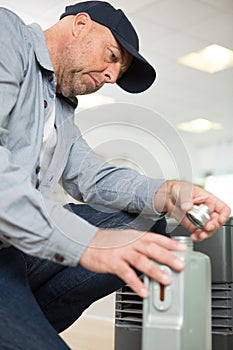 technician checking liquid electric stove