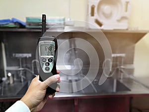 Technician checking Temperature and Humidity in central sterile supply department.