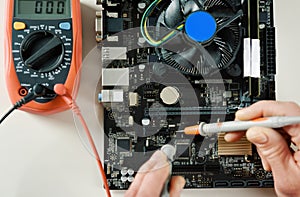 A technician checks the serviceability of motherboard