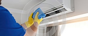 The technician cleaning an air-conditioning unit for optimal performance..AI generated image