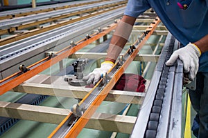 The technician cleaning conveyor belt in production line at factory plant photo