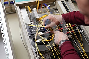 Technician cleaning fiber optic