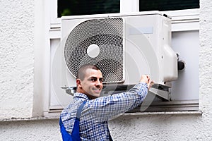 Technician Cleaning And Repairing Air Condition Appliance