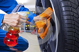 Technician cleaning a tire at workshop