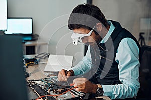 Technician, computer and engineer repair motherboard, microcircuit or electronic device in a workshop or shop. Person