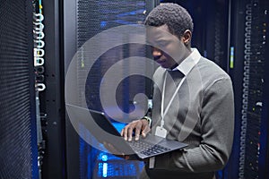 Technician Configuring Servers in Data Center