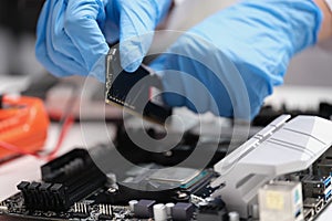 Technician connects CPU microprocessor to motherboard socket