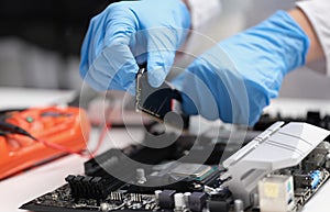 Technician connects CPU microprocessor to motherboard socket