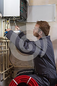 Technician controlling the heating system